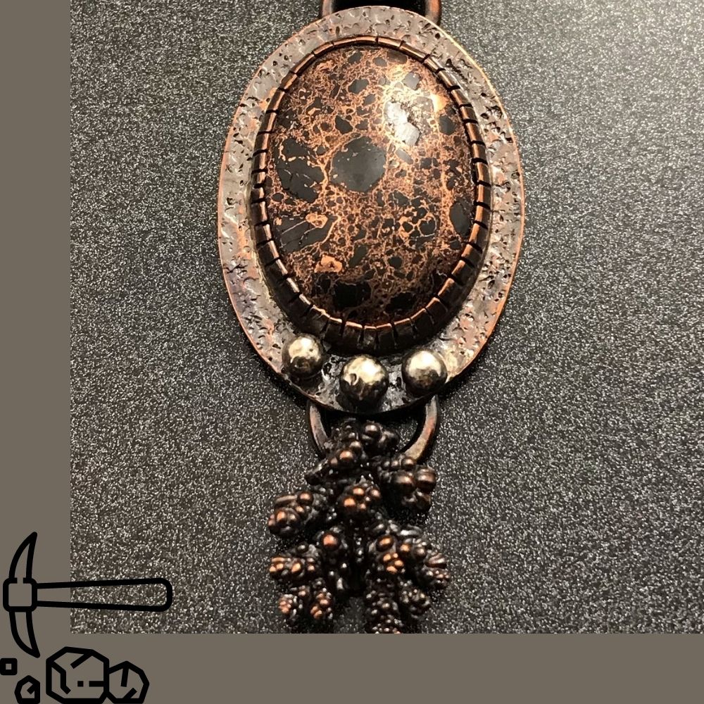 A large copper pendant made with Copper Firebrick as the focal stone and three silver orbs and a copper "short" from a Keweenaw Peninsula copper mine located in Michigan's Upper Peninsula.